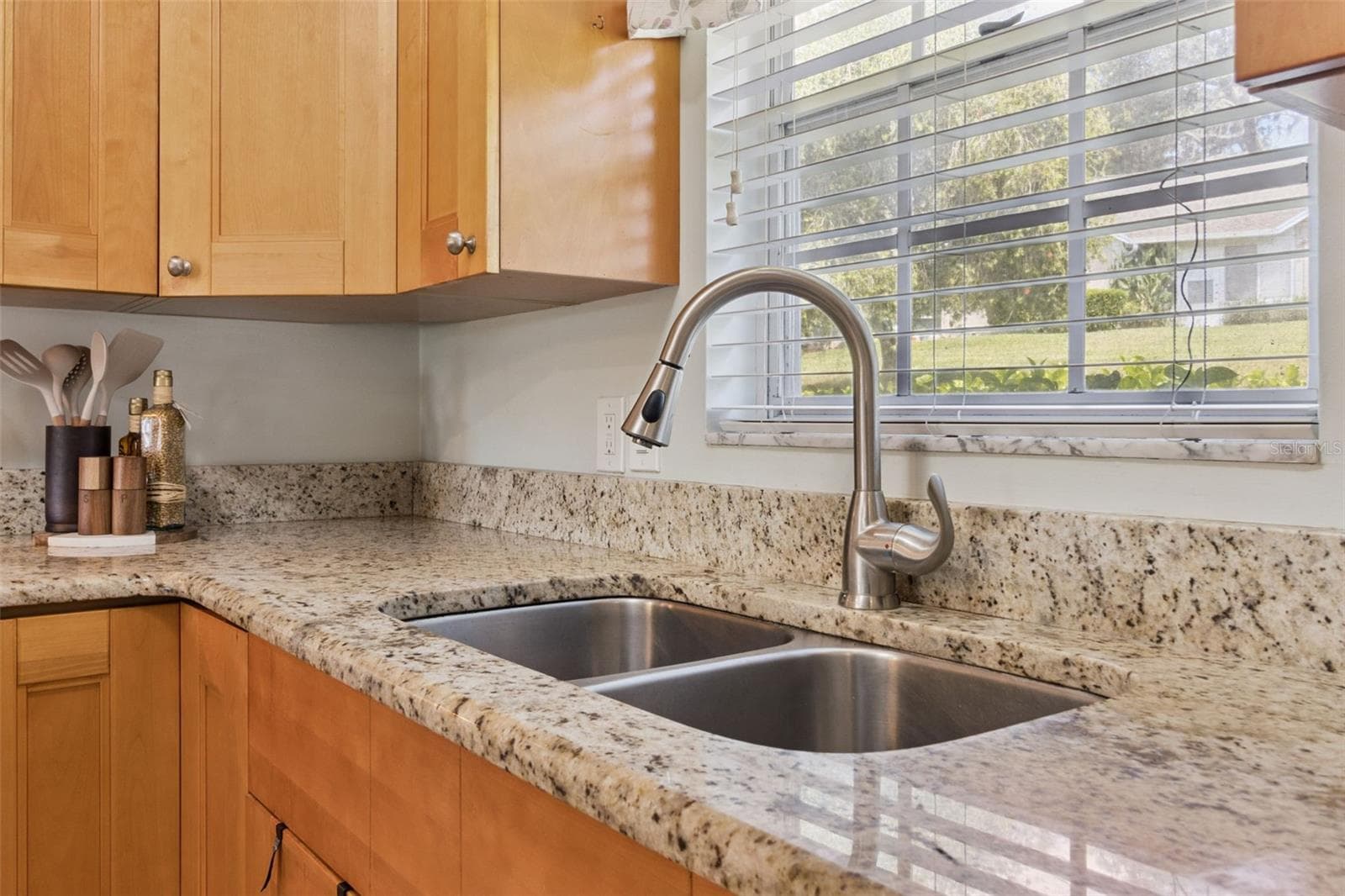 Culinary hosts appreciate the 42" cabinets to the ceiling, pull-out shelves, lazy Susan, and window that brings in natural sunlight over the deep, double kitchen sink. - 1066 VILLA LN #63, APOPKA