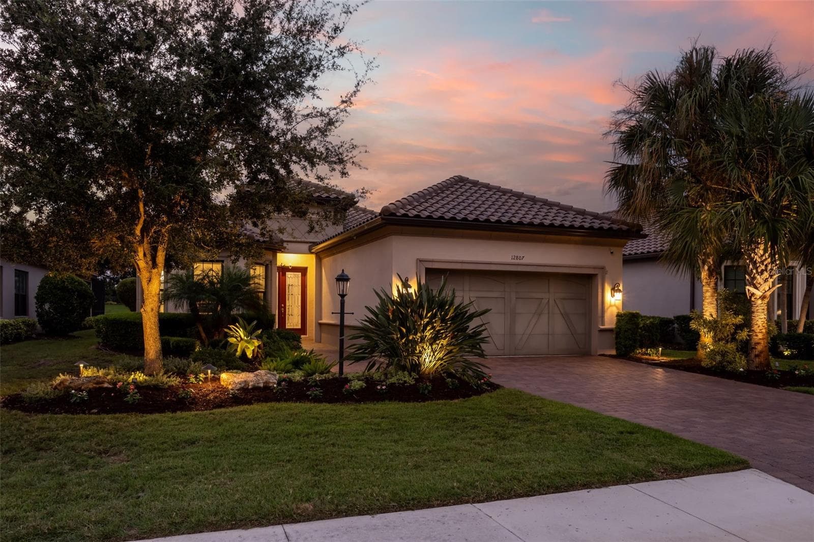 Landscape lighting accents the front - 12807 SORRENTO WAY, BRADENTON