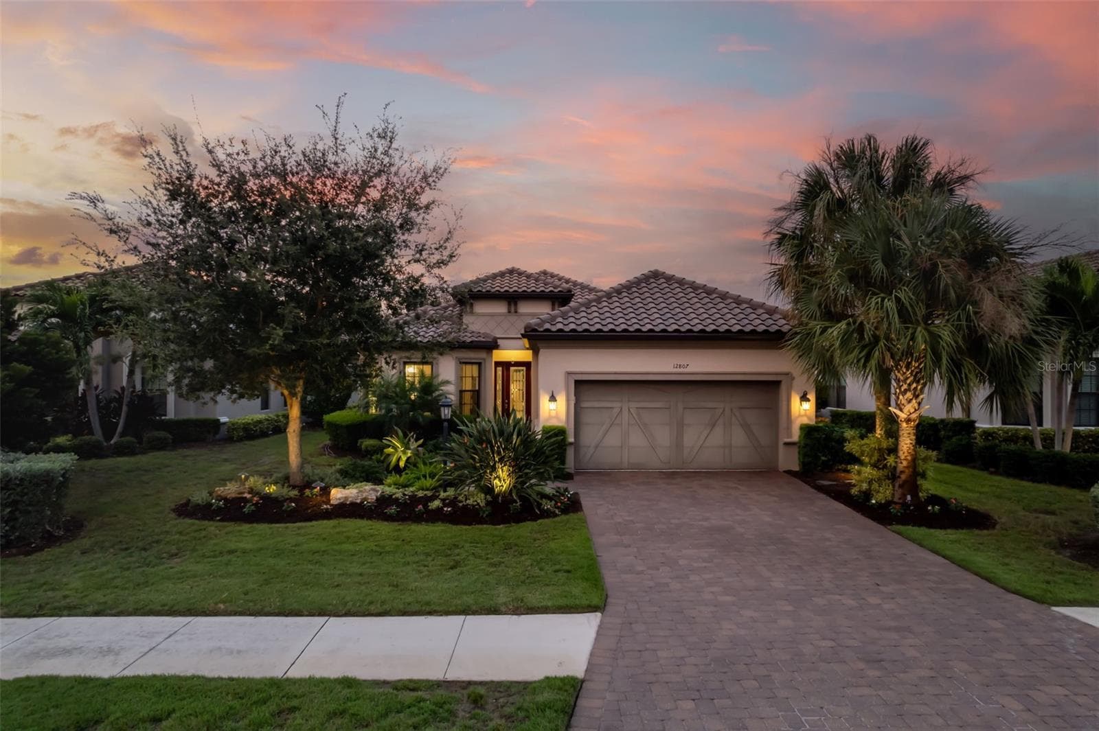 Paver driveway and custom garage door add detail - 12807 SORRENTO WAY, BRADENTON