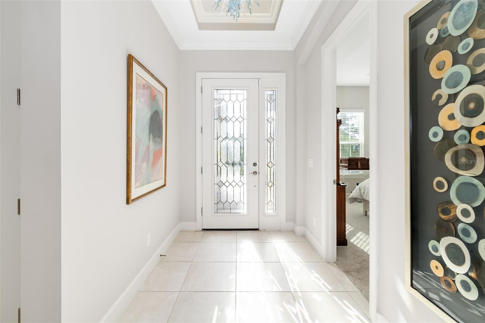 Inside, the foyer hallway is filled with natural light - 12807 SORRENTO WAY, BRADENTON