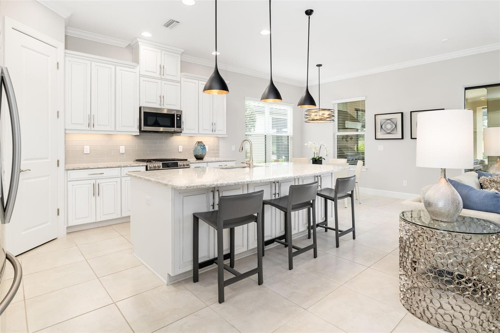 A large island with counter seating is an inviting place to chat with the chef - 12807 SORRENTO WAY, BRADENTON