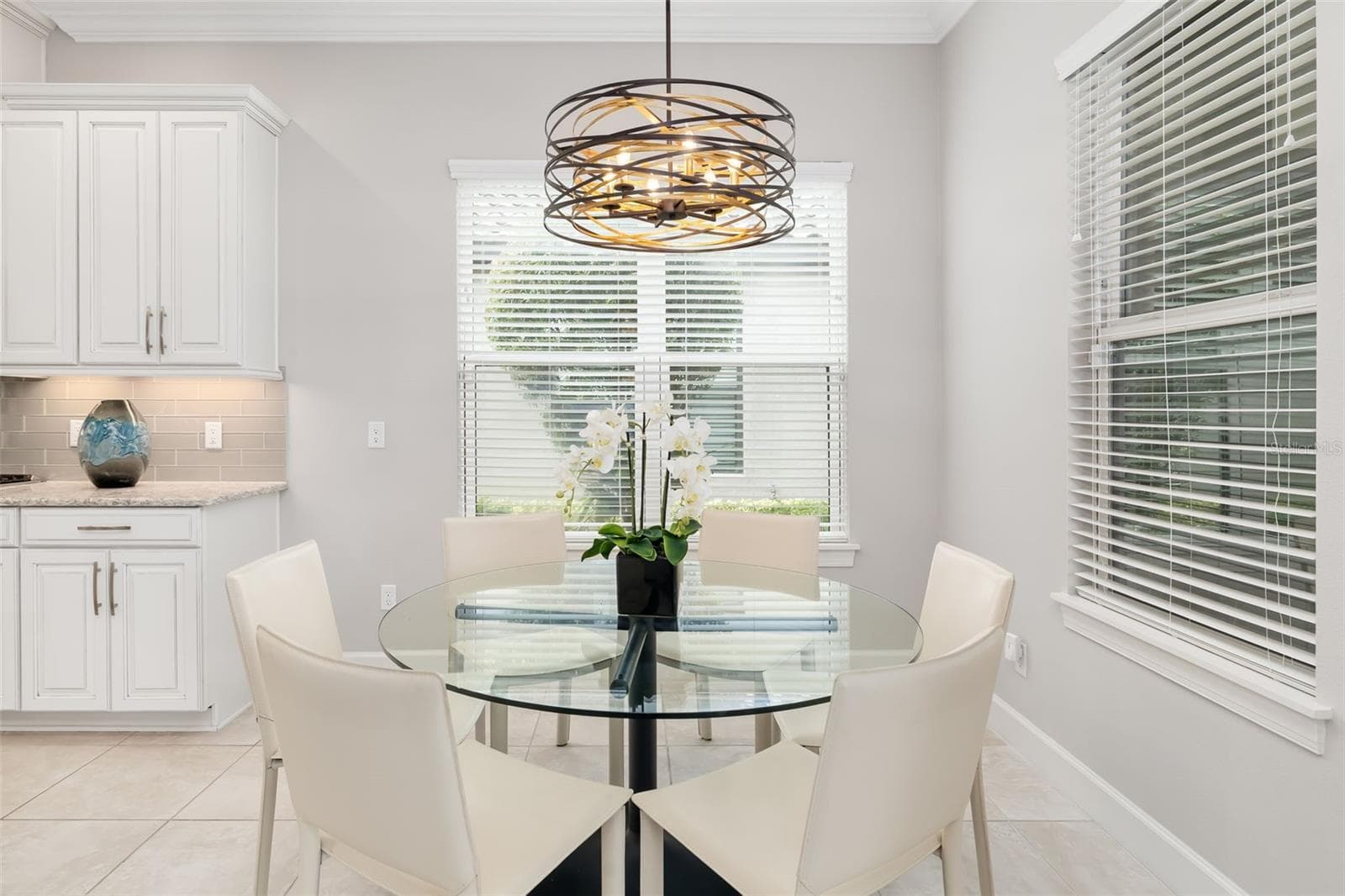 The dining area overlooks the lanai and windows offer an abundance of natural sunlight - 12807 SORRENTO WAY, BRADENTON