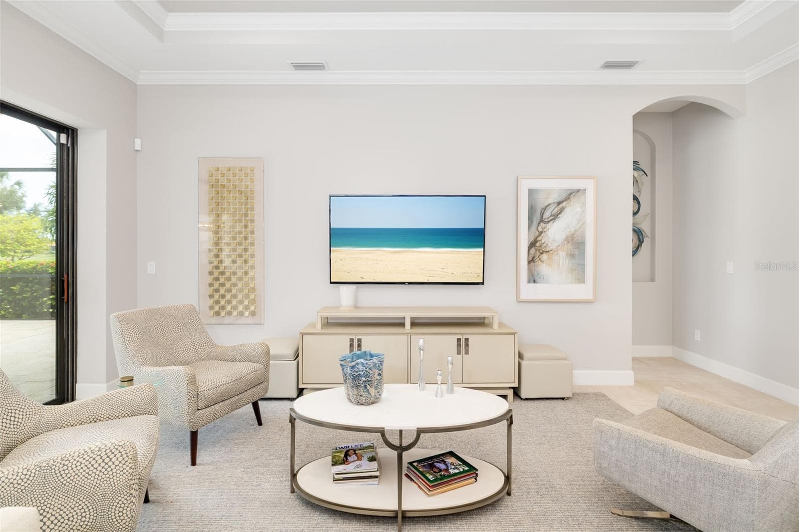 The great room is defined by a tall tray ceiling with crown molding. - 12807 SORRENTO WAY, BRADENTON
