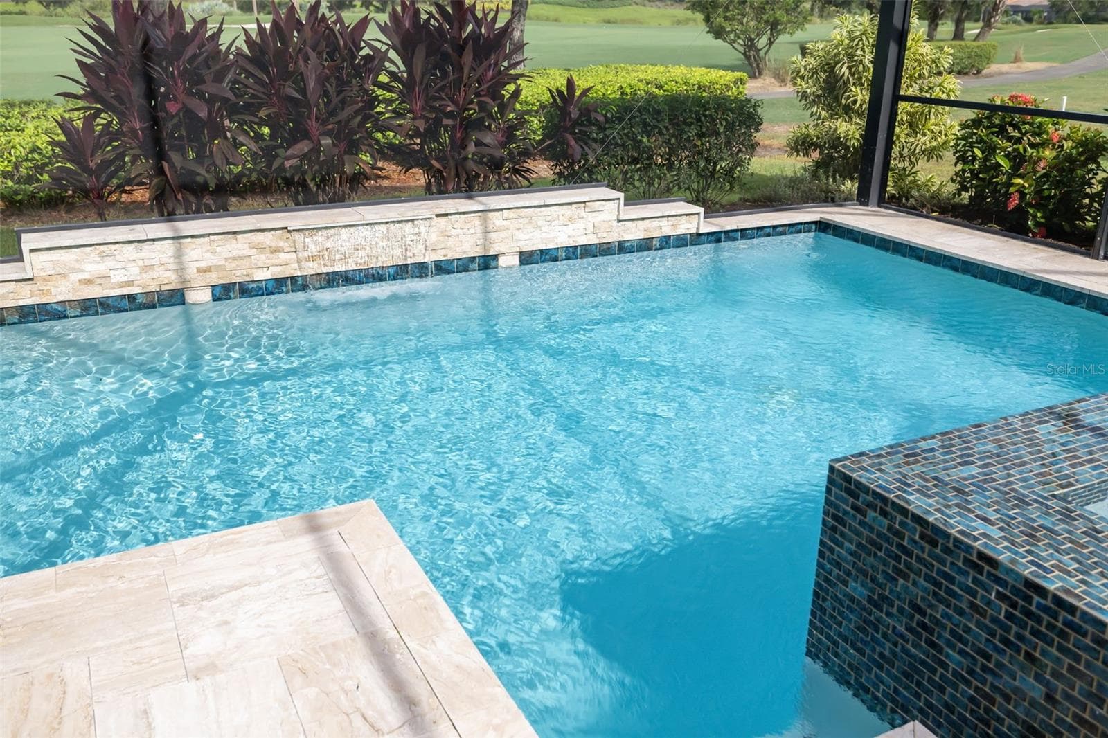 A waterfall feature adorn the decorative opposite wall of the pool - 12807 SORRENTO WAY, BRADENTON