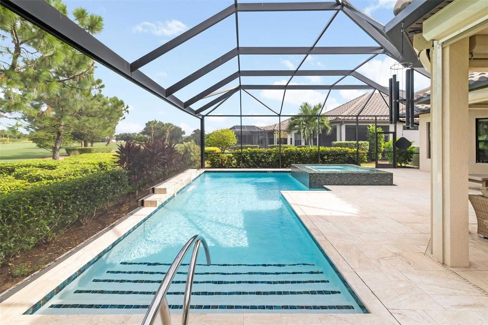 Landscaping surrounds the pool - 12807 SORRENTO WAY, BRADENTON