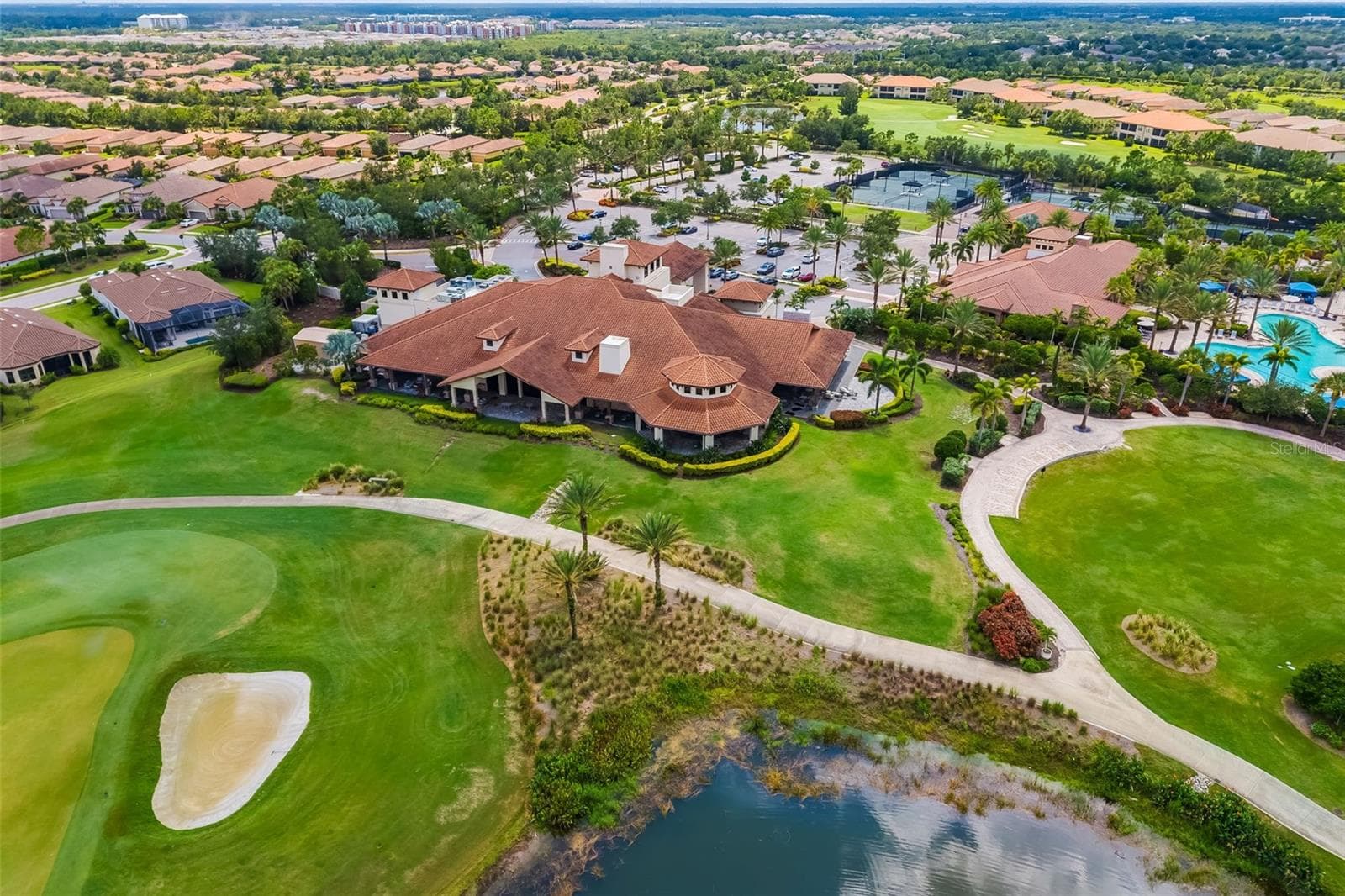 The Club House sits at the end of the 18th green. The rear lanai has a sitting area and outdoor access to the Barrel House bar. - 12807 SORRENTO WAY, BRADENTON