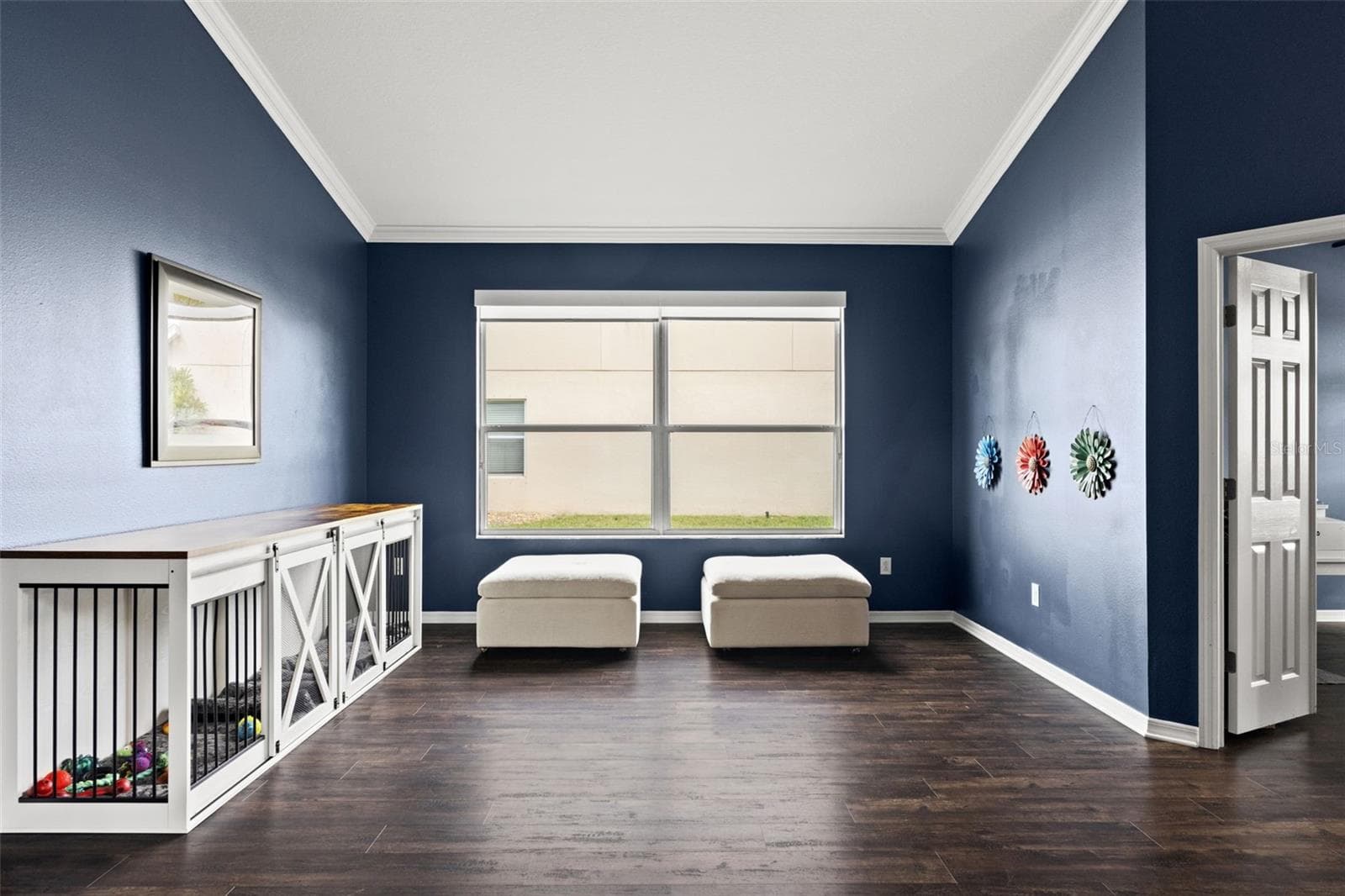 Large front windows fill this versatile living space with natural light while the open layout keeps the home feeling connected. - 1419 BLUE MARLIN BLVD, HOLIDAY