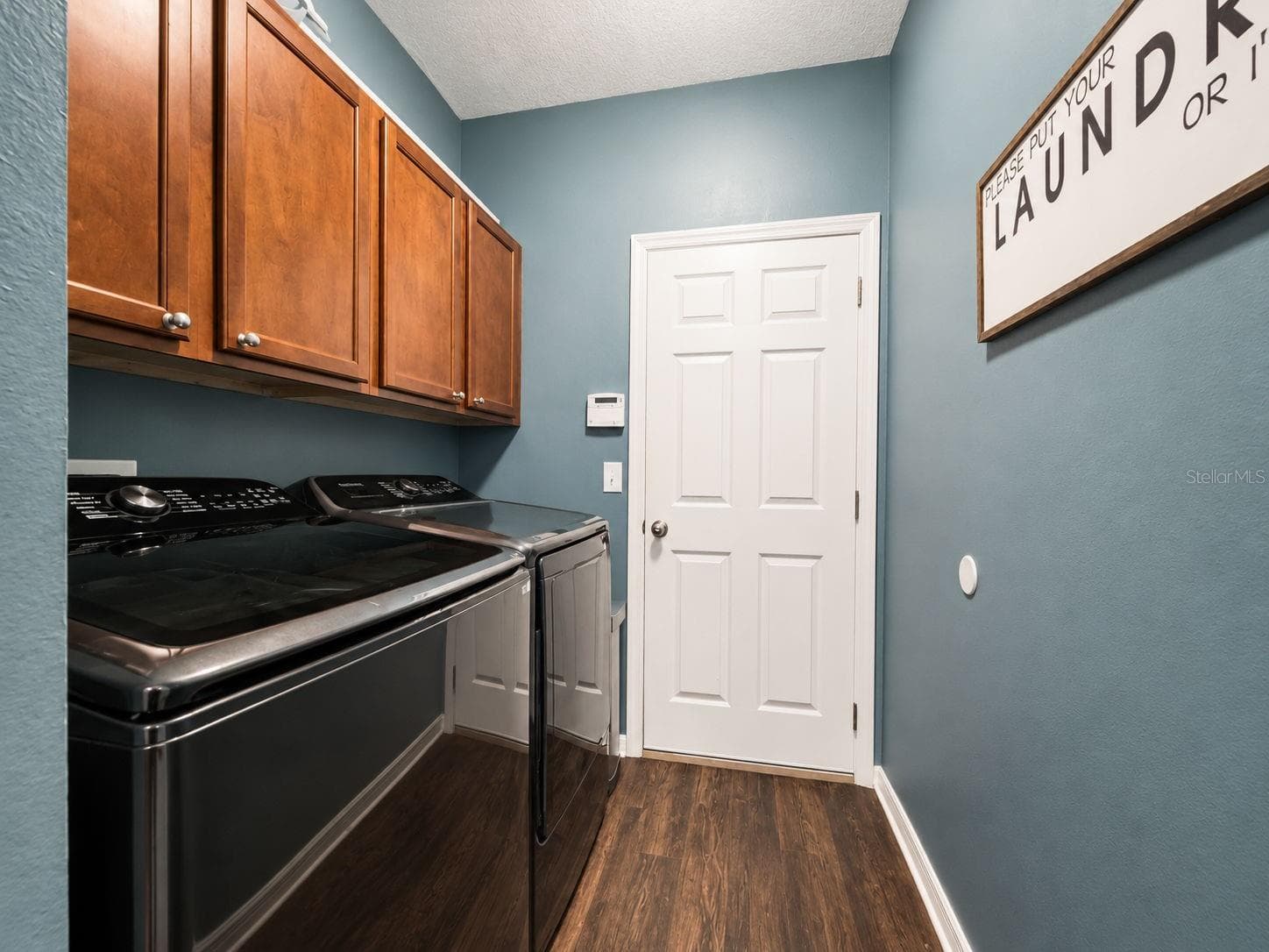The conveniently located laundry room provides additional cabinetry and direct access to the garage. - 1419 BLUE MARLIN BLVD, HOLIDAY