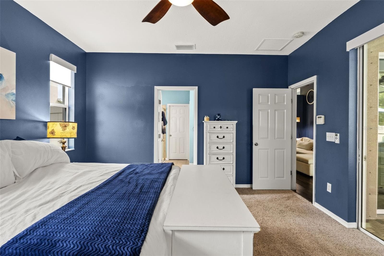 Tucked into the split-bedroom floor plan, the primary suite creates a private retreat away from the secondary bedrooms. - 1419 BLUE MARLIN BLVD, HOLIDAY