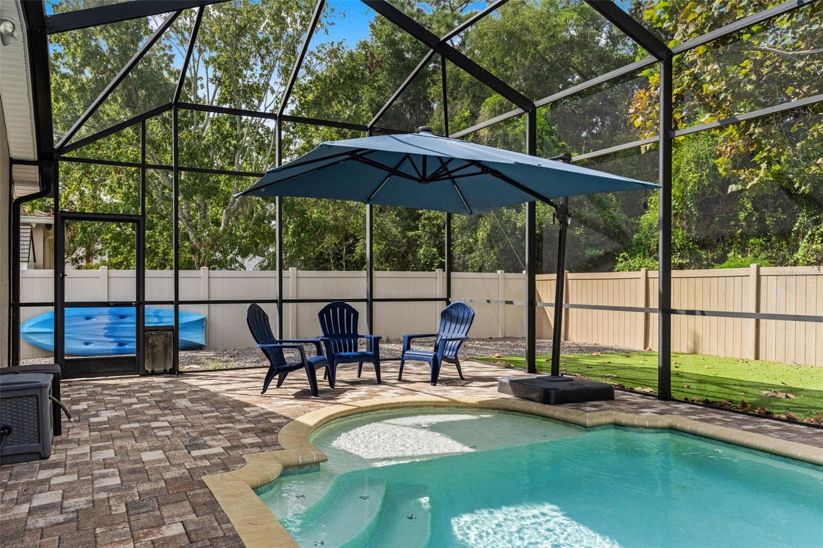 Sun or shade? There’s room for both, with open poolside space complemented by a large umbrella-covered seating area. - 1419 BLUE MARLIN BLVD, HOLIDAY