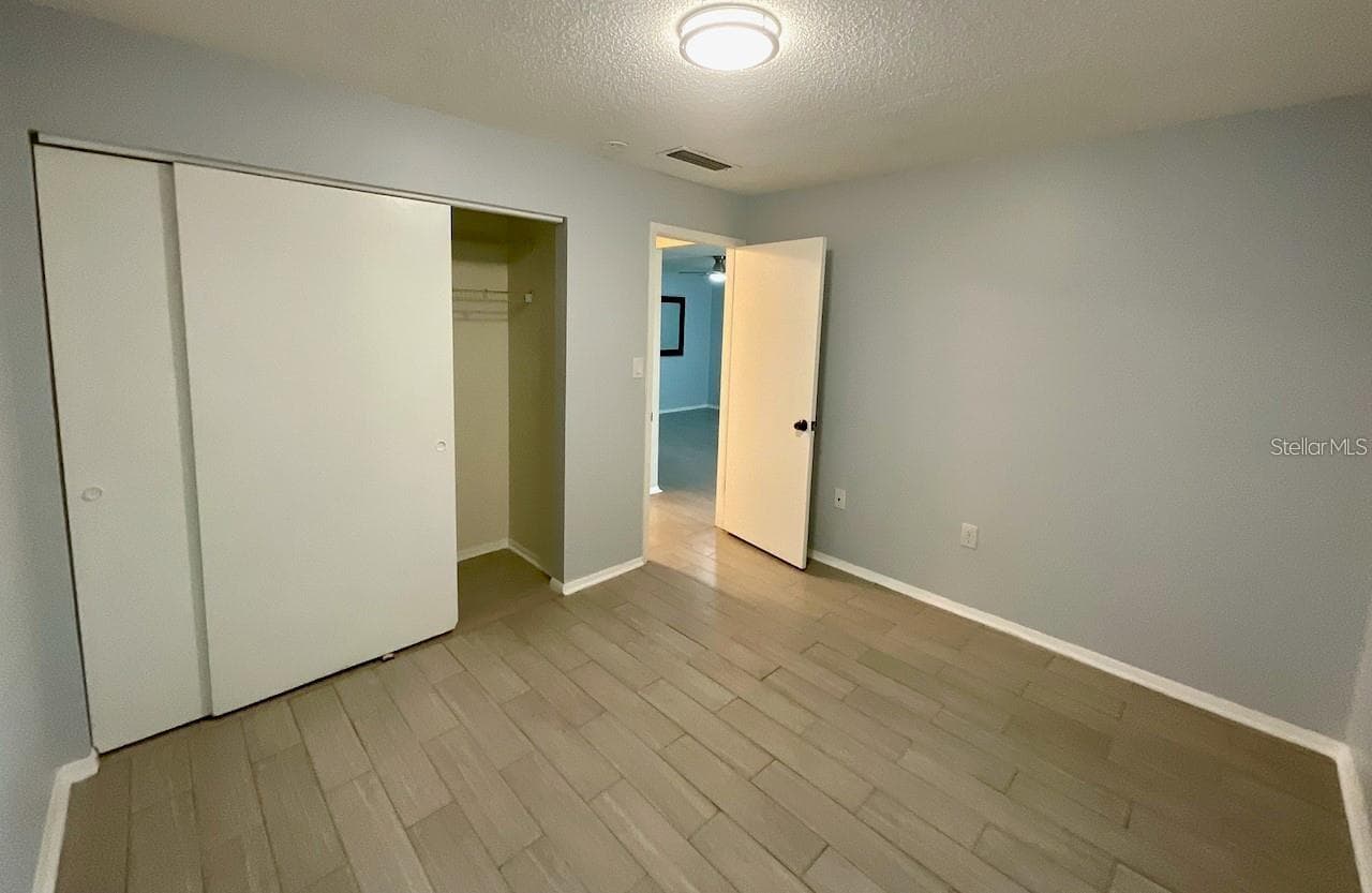 Bedroom 1 with large closet and door to hallway - 1020 85TH AVE N #222, ST PETERSBURG