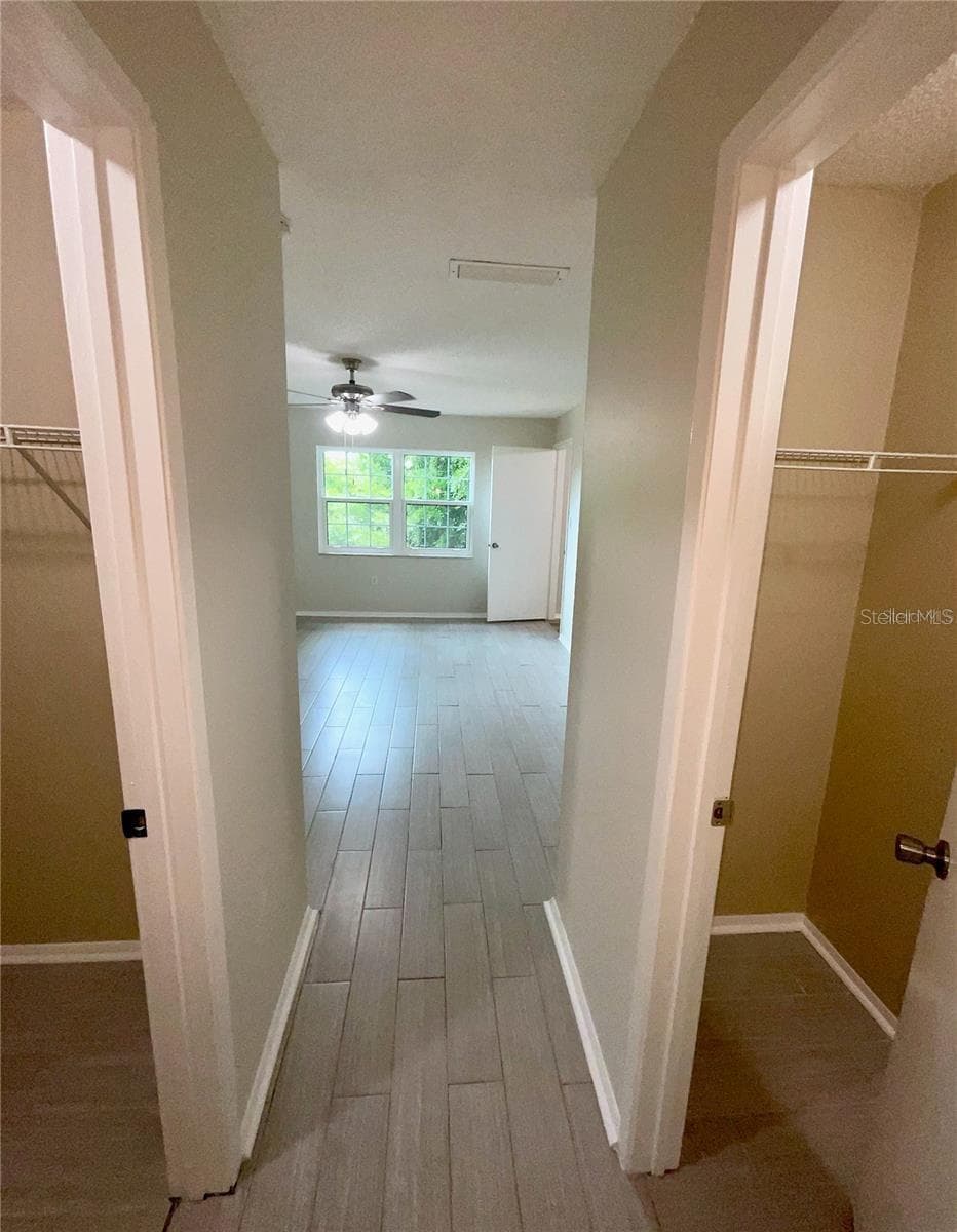 2nd bedroom entry with large walk-in closet on left and another closet on the right. - 1020 85TH AVE N #222, ST PETERSBURG