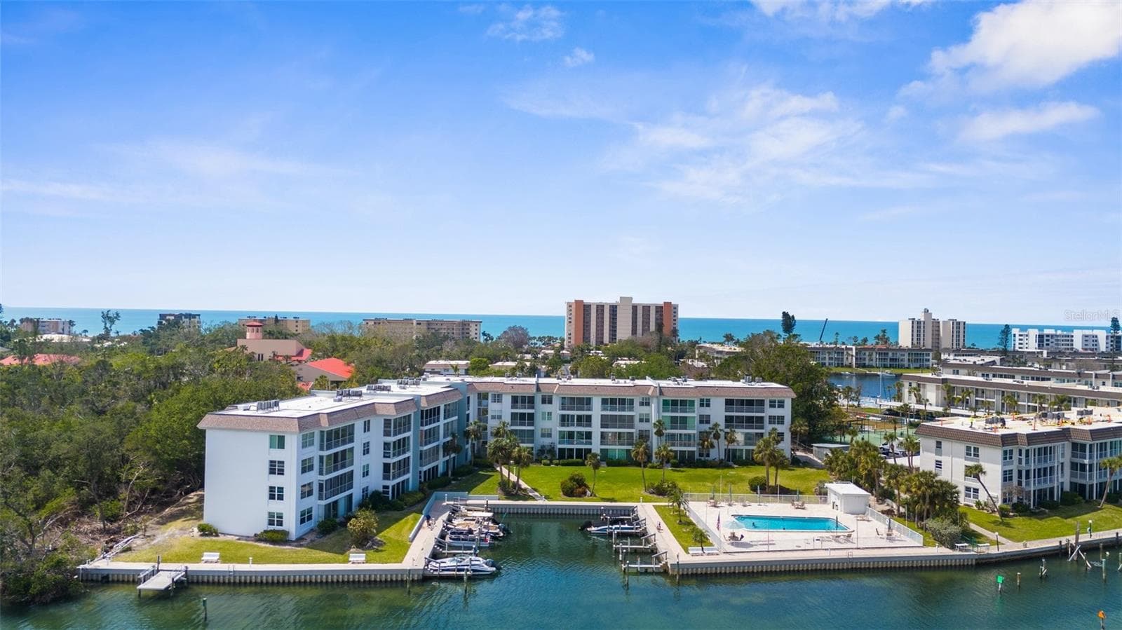 Aerial View of Association with boat docks, pool, electric kayak launch - 600 SUTTON PL #101B, LONGBOAT KEY