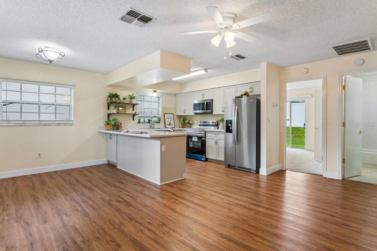 Living area view with kitchen, bedroom and bathroom - 6709 DEVONSHIRE LN #10A, NEW PORT RICHEY