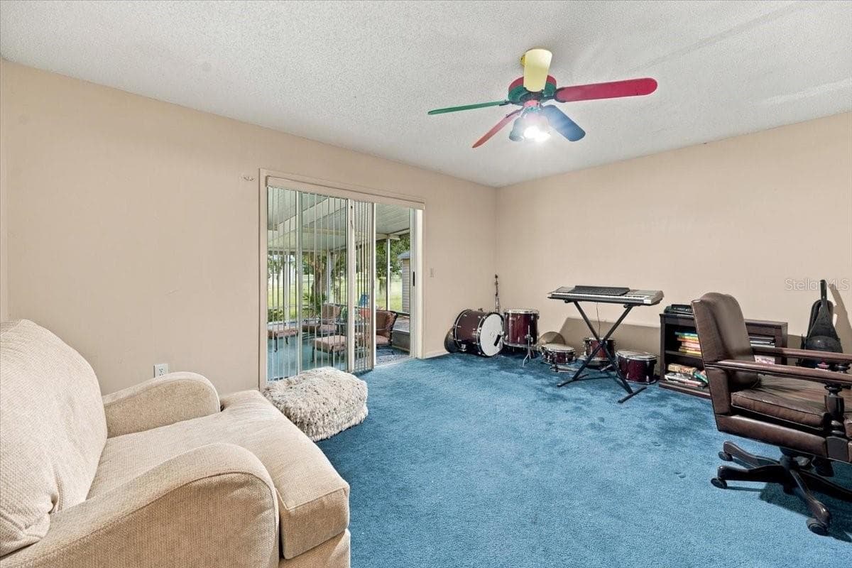 Bedroom 4 with sliding doors to side screened lanai - 4437 FLINTLOCK LOOP, LAKELAND