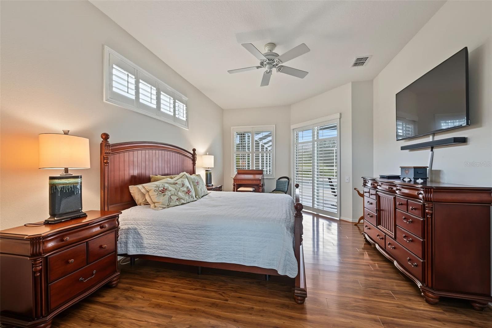 Primary Bedroom with sliders to lanai/pool area - 1028 HAGEN DR, NEW PORT RICHEY