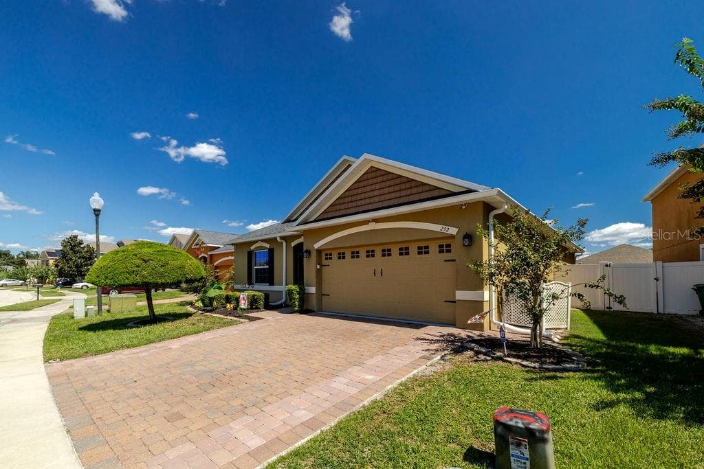Side view of home with oversized paver driveway - 252 SHERRI LEE LN, DELAND
