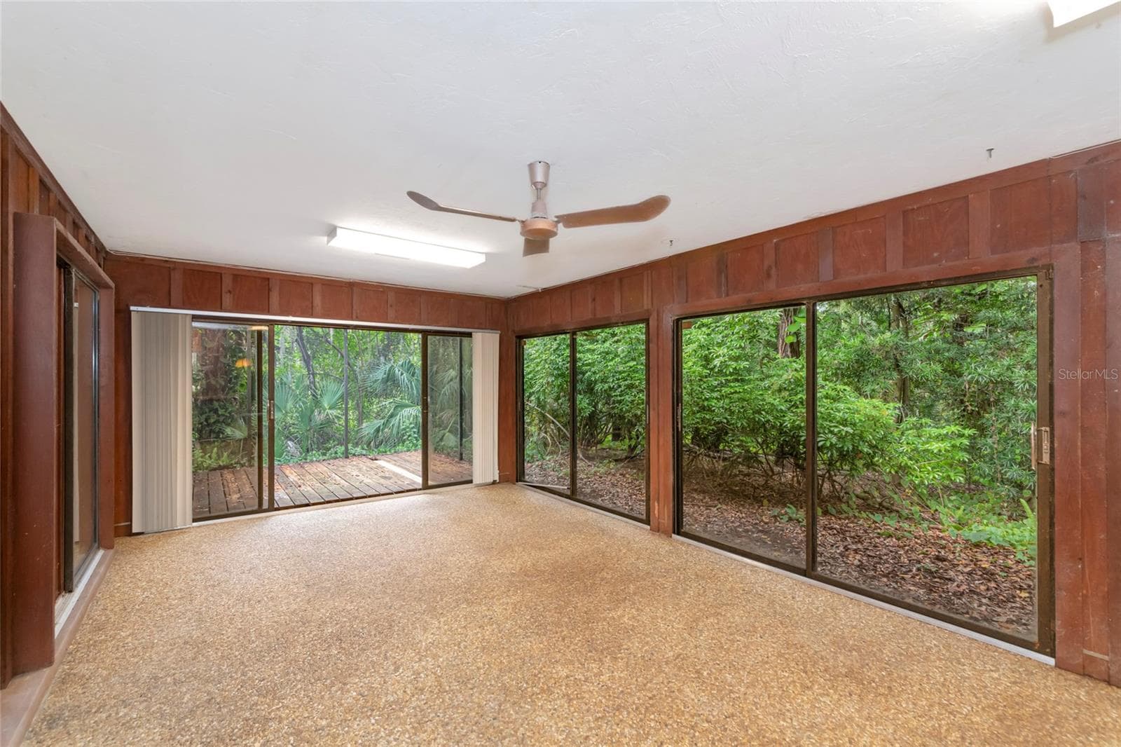 Walls of Glass opens to the wooded yard. - 4781 STONE RIDGE TRL, SARASOTA
