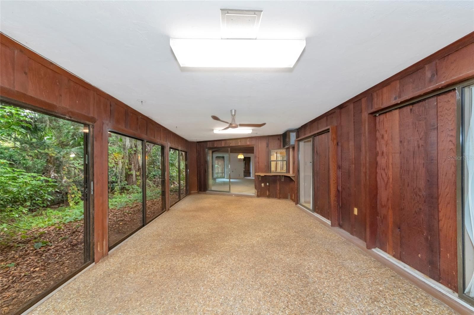 Large Florida Room with Multiple Sets of Sliders to the Primary Bedroom and Dining Room - 4781 STONE RIDGE TRL, SARASOTA