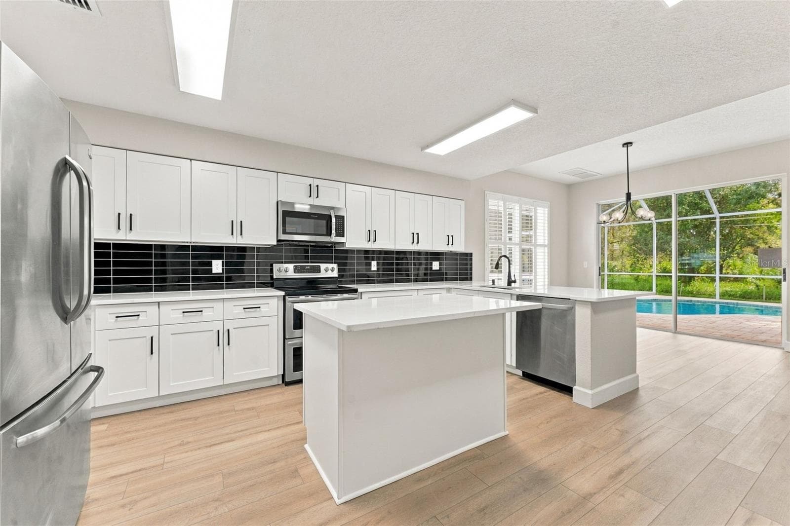 Entering the kitchen which was remodeled in 2026 - 10102 VISTA POINTE DR, TAMPA