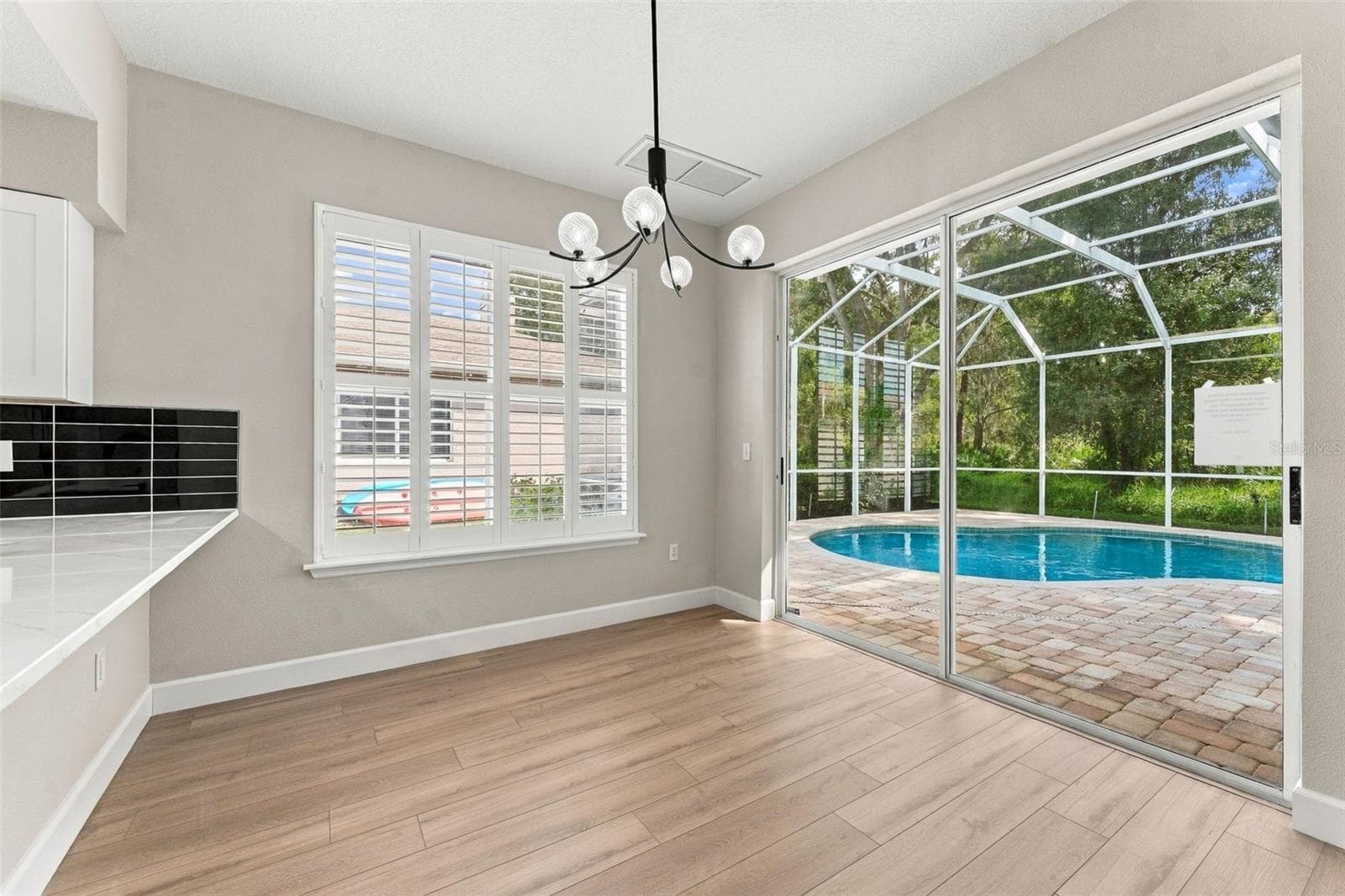 Breakfast nook located off the kitchen with a great view of the pool and woods behind your home - 10102 VISTA POINTE DR, TAMPA