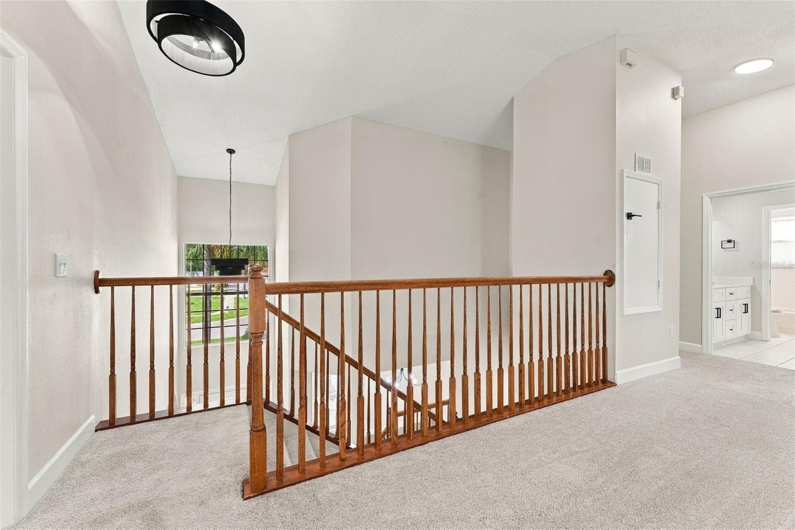 At the top of the stairs you enter into the bonus room/loft area - 10102 VISTA POINTE DR, TAMPA