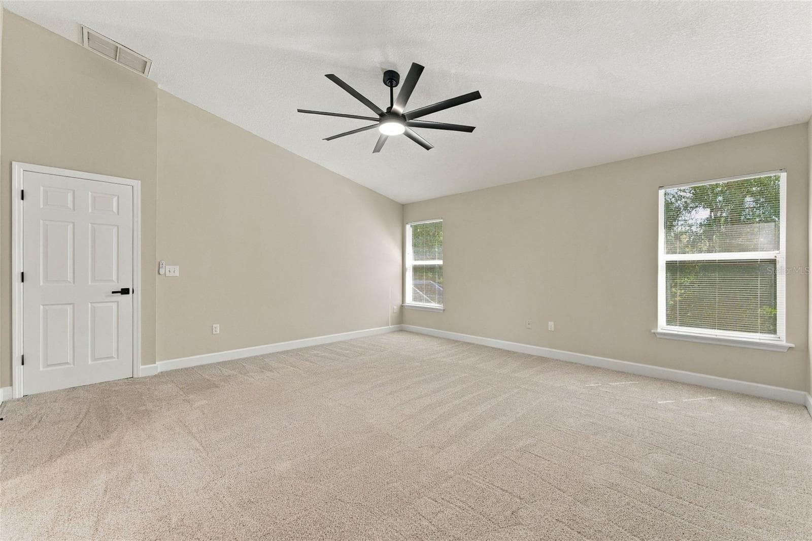 Primary bedroom with brand new carpet and ceiling fan - 10102 VISTA POINTE DR, TAMPA