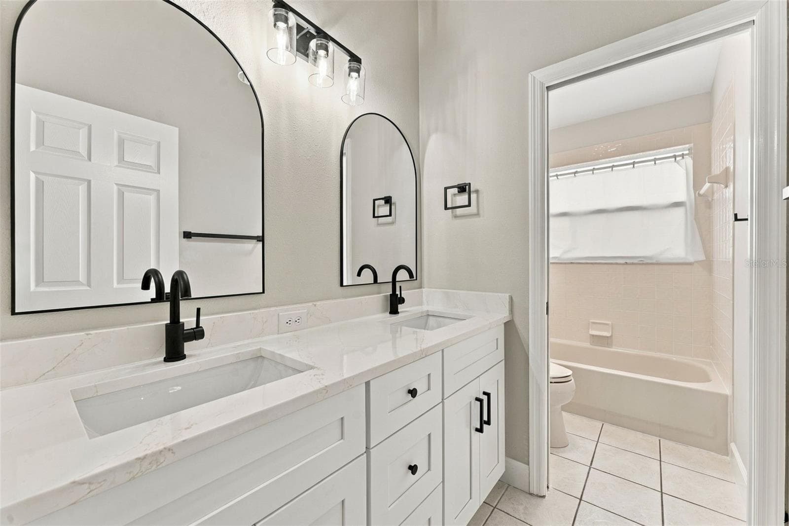 Hall bathroom upstairs with new dual vanity, lighting, mirrors & fixtures - 10102 VISTA POINTE DR, TAMPA
