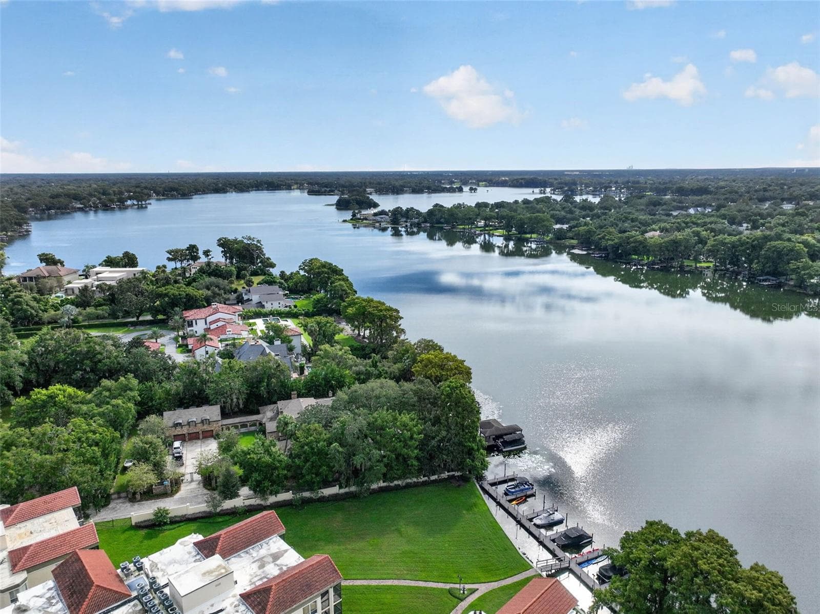 LAKEFRONT AERIAL SHOT WITH COMMUNITY GROUNDS + PRIVATE BOAT SLIPS / DOCK - 223 QUAYSIDE CIR #C11, MAITLAND