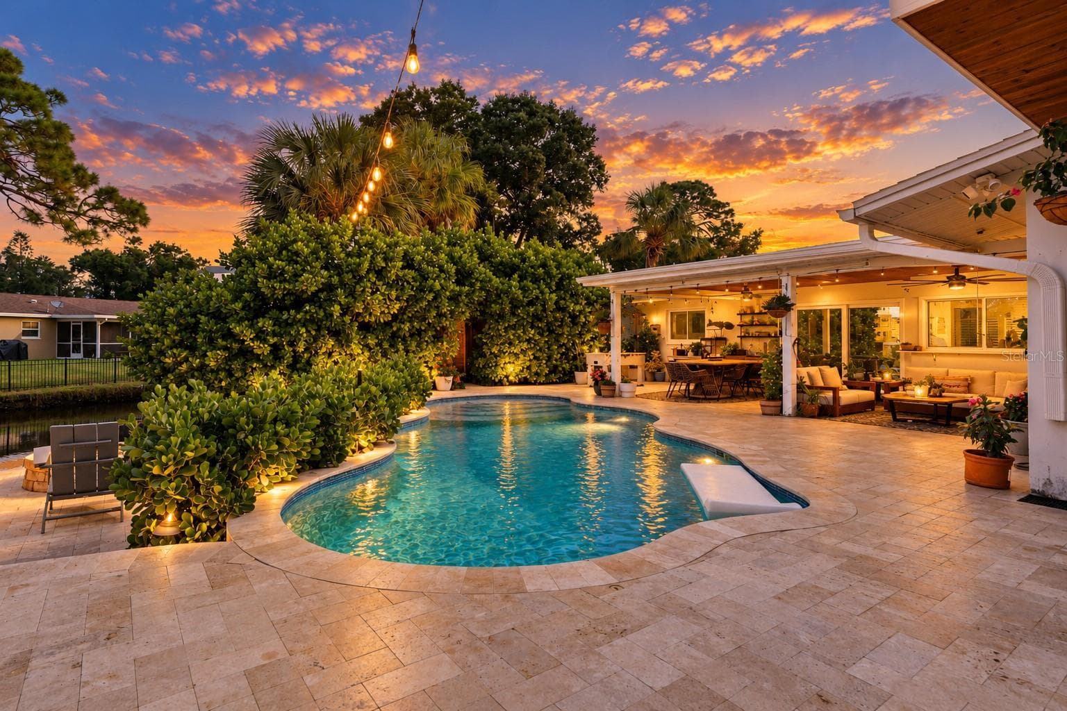 Twilight View of Saltwater Pool and Entertainment Space - 4785 BUTTERFLY PL NE, ST PETERSBURG