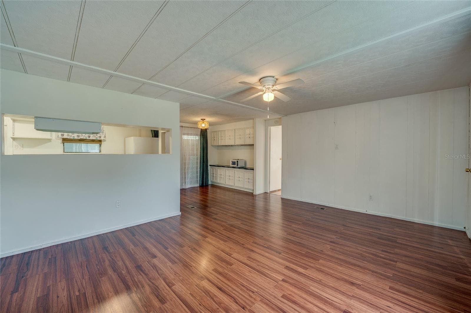 Open and flexible interior layout provides ample room for separate living and dining zones, with a convenient pass-through to the kitchen. - 128 KON TIKI TER, PORT ORANGE