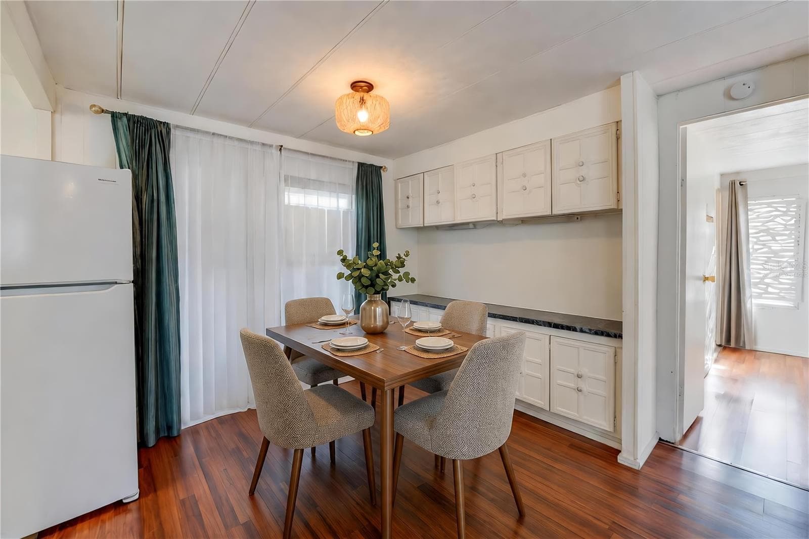 Virtually Staged - Dedicated dining space features extensive built-in cabinetry and countertop space, with a large window bringing natural light into the room. - 128 KON TIKI TER, PORT ORANGE
