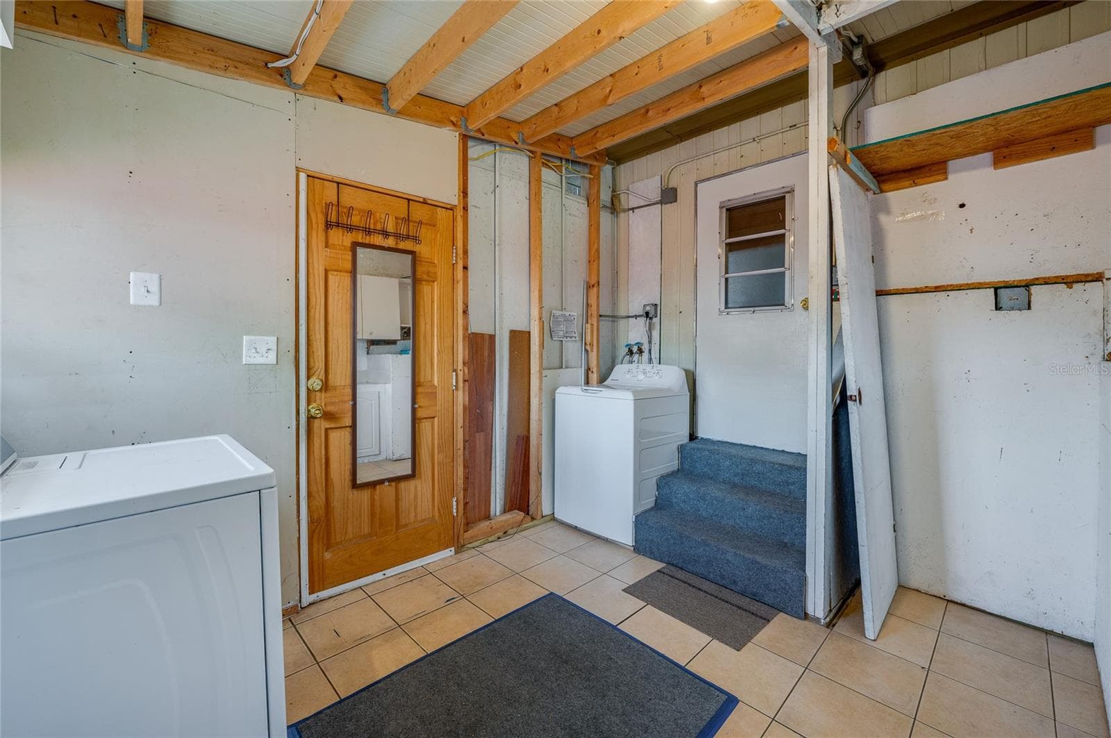 Separate laundry area provides space for laundry appliances along with additional room for household storage and utility needs. - 128 KON TIKI TER, PORT ORANGE