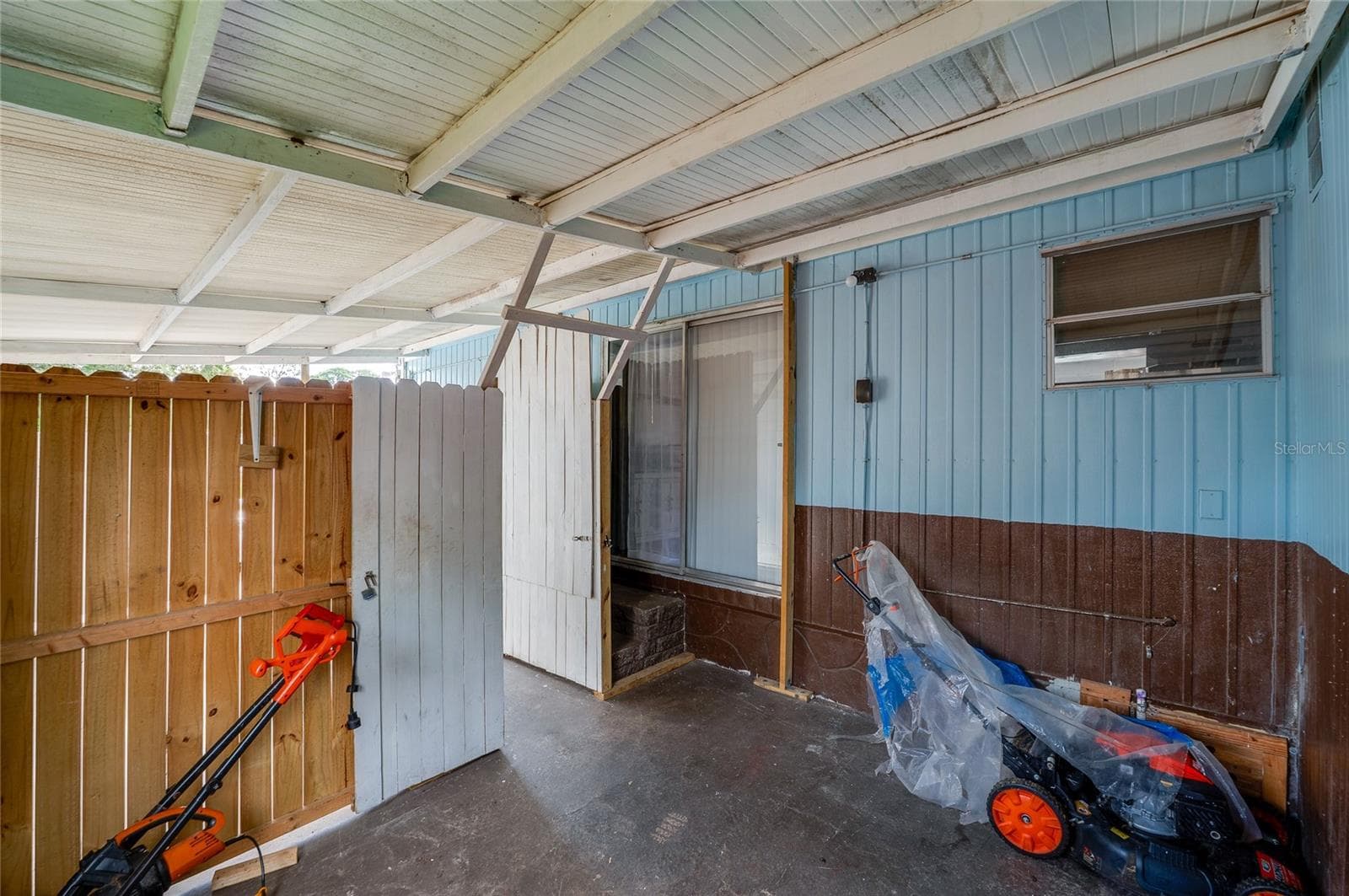 Covered outdoor area provides a sheltered extension of the home with direct access to the interior. - 128 KON TIKI TER, PORT ORANGE