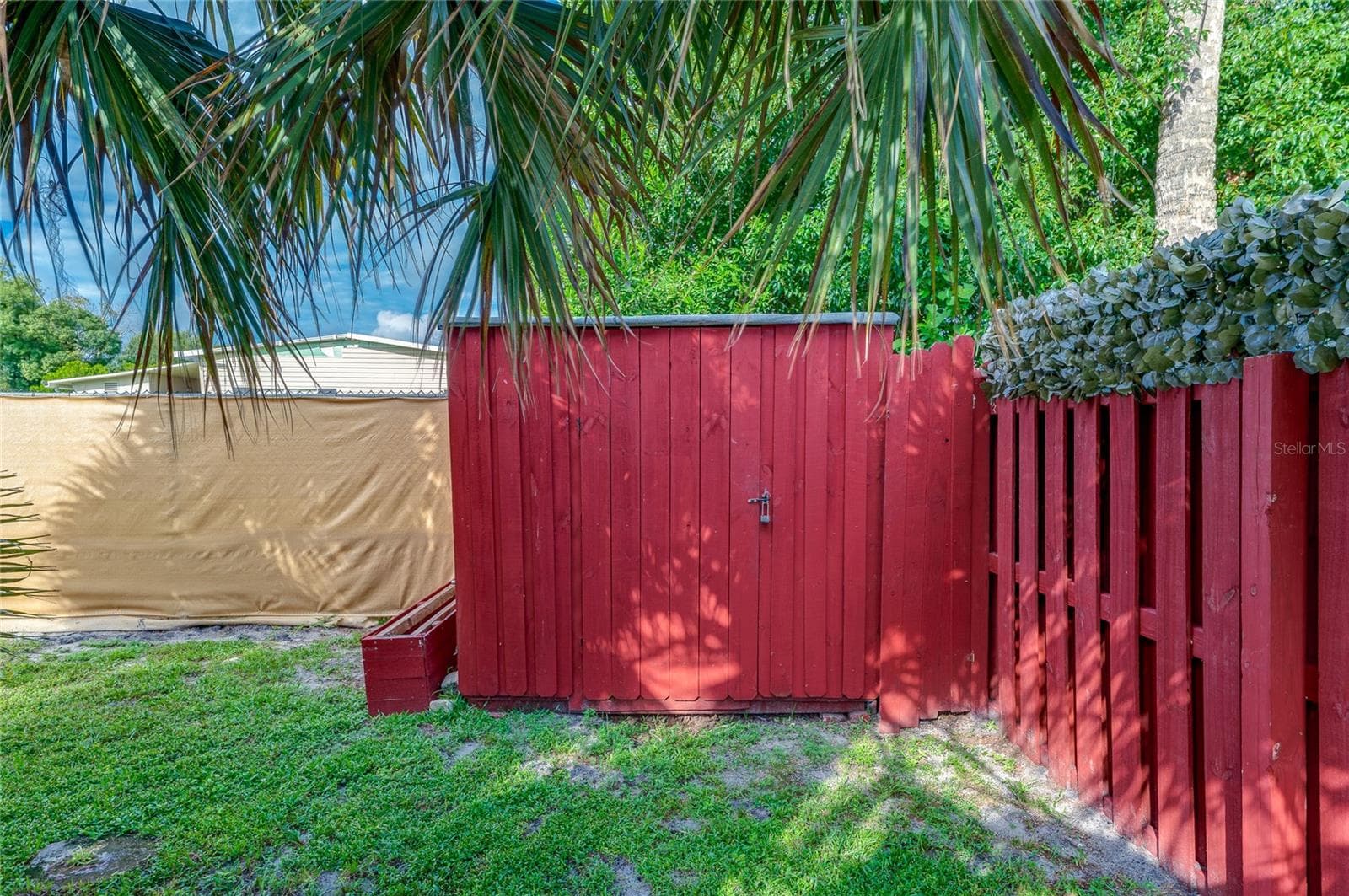 Freestanding storage shed provides a dedicated space for lawn equipment, tools, and other outdoor items, with convenient access from the backyard. - 128 KON TIKI TER, PORT ORANGE