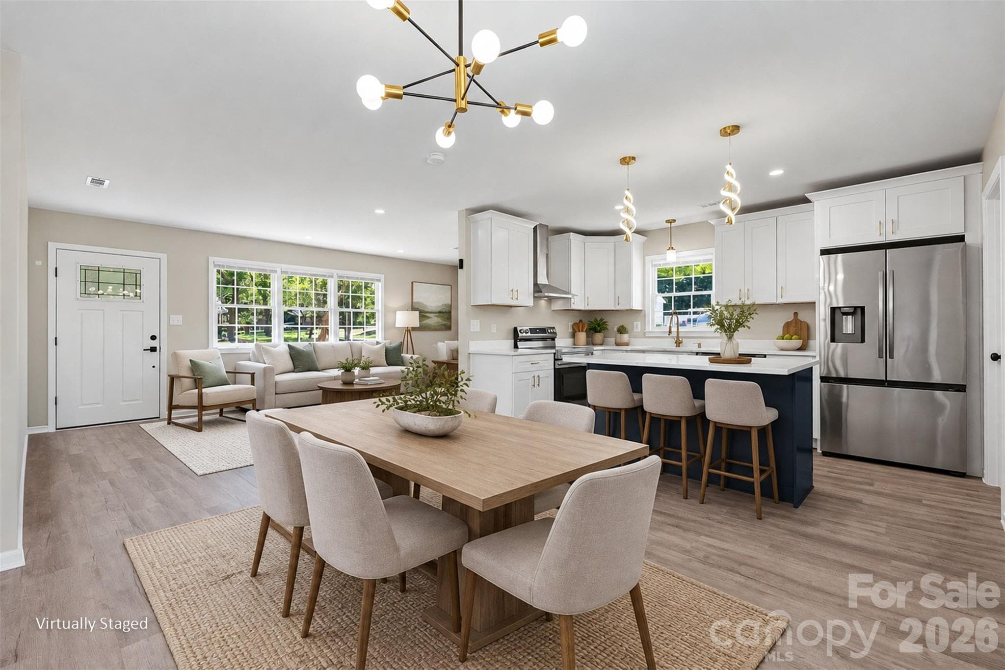 Seamless open-concept layout connecting the dining space, living room, and modern kitchen with a contrasting center island. (Virtually Staged) - 3801 Hillock Court, Charlotte