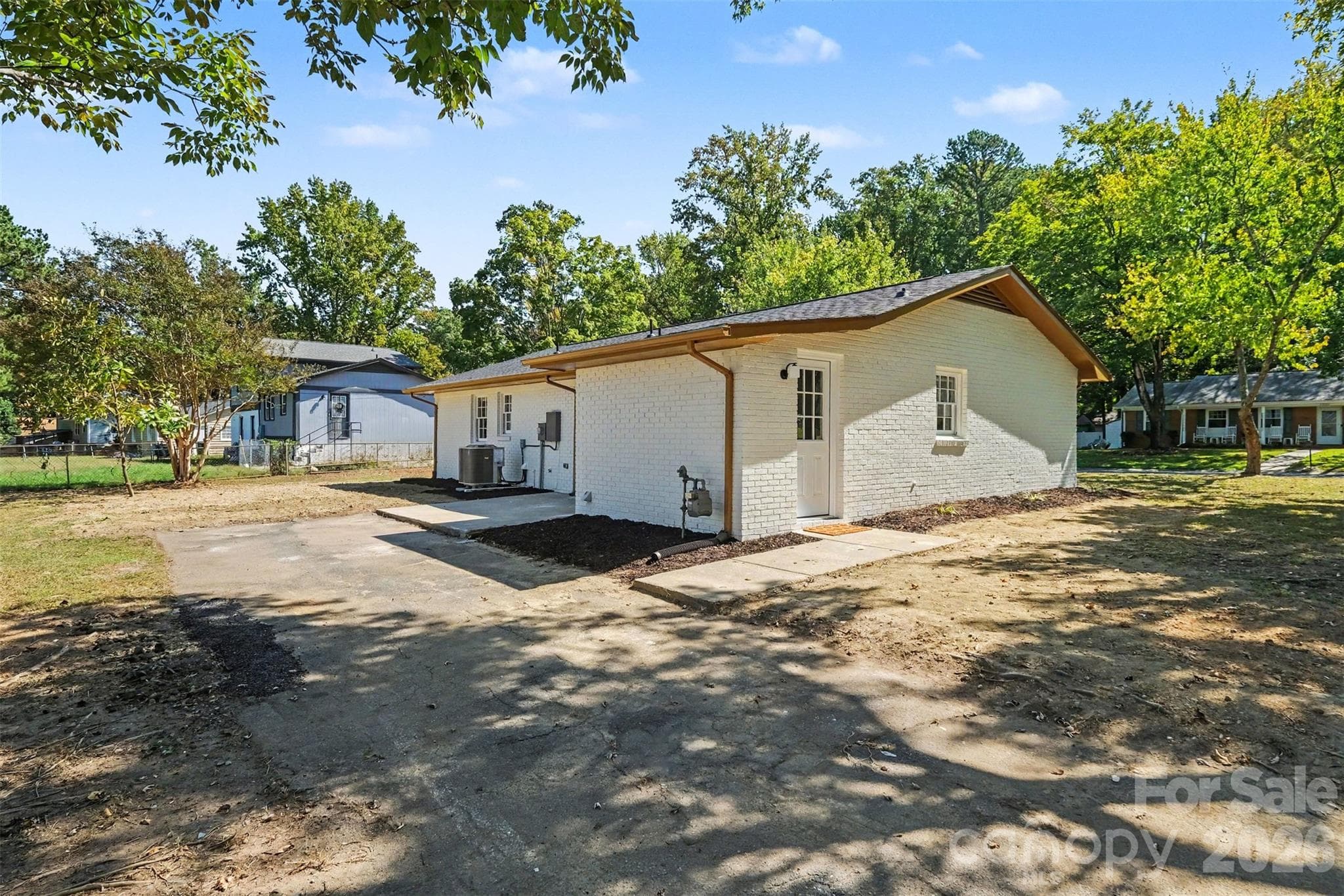 Convenient side door access into the home via the laundry room, with direct entry into the kitchen and plenty of off-street parking space. - 3801 Hillock Court, Charlotte