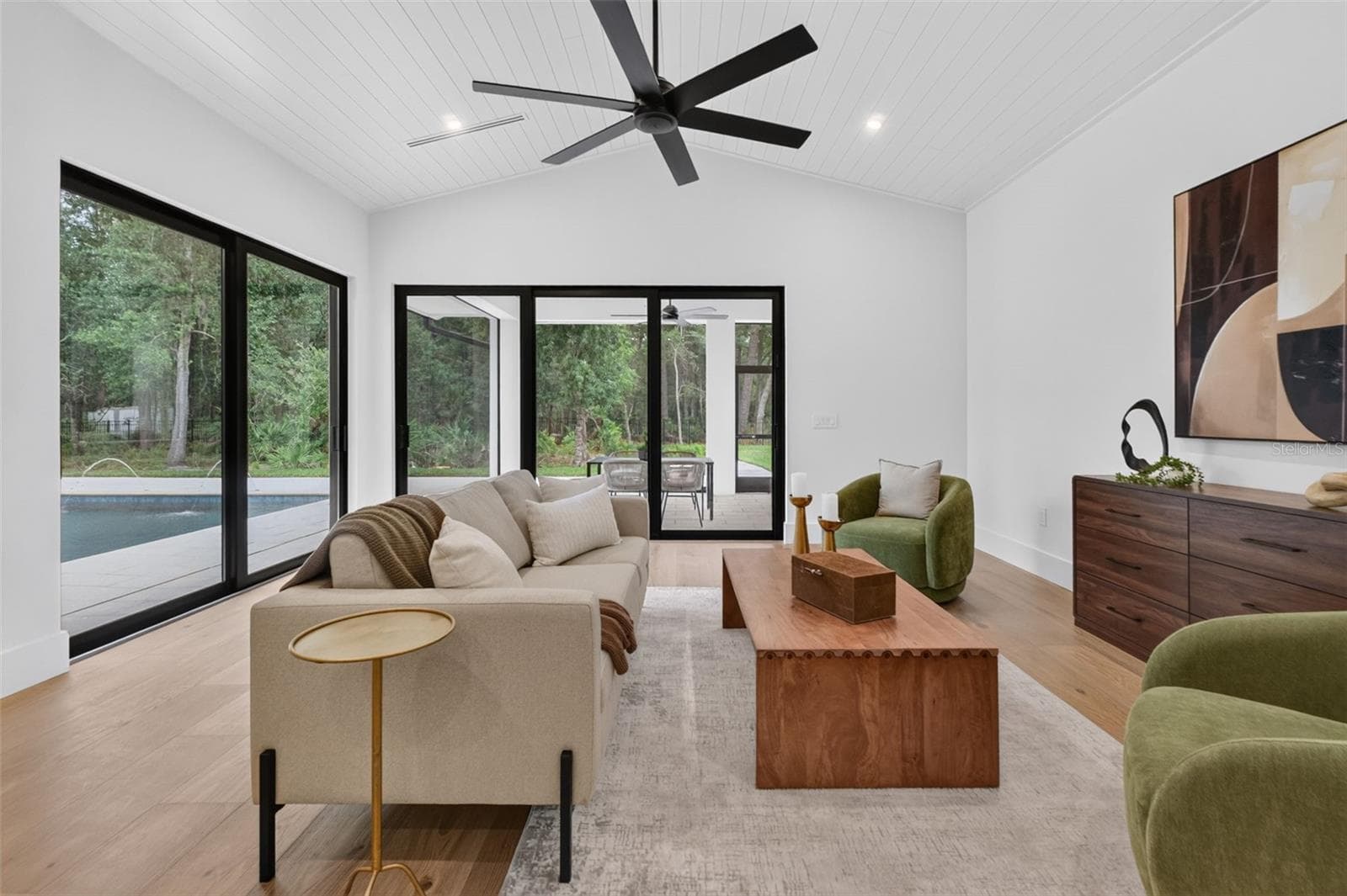 Game room features a wet bar with beverage refrigerator and two large sliding glass doors that provide direct access to pool and covered lanai - 1815 WINDERMERE RD, WINDERMERE