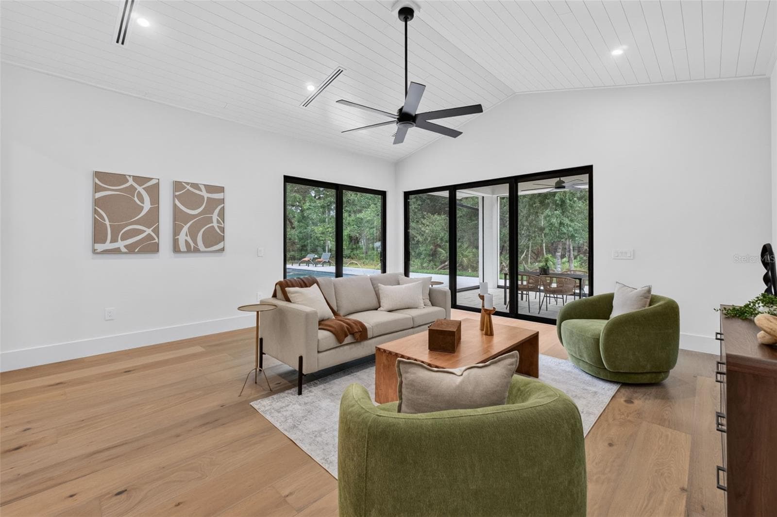 Game room features a wet bar with beverage refrigerator and two large sliding glass doors that provide direct access to pool and covered lanai - 1815 WINDERMERE RD, WINDERMERE