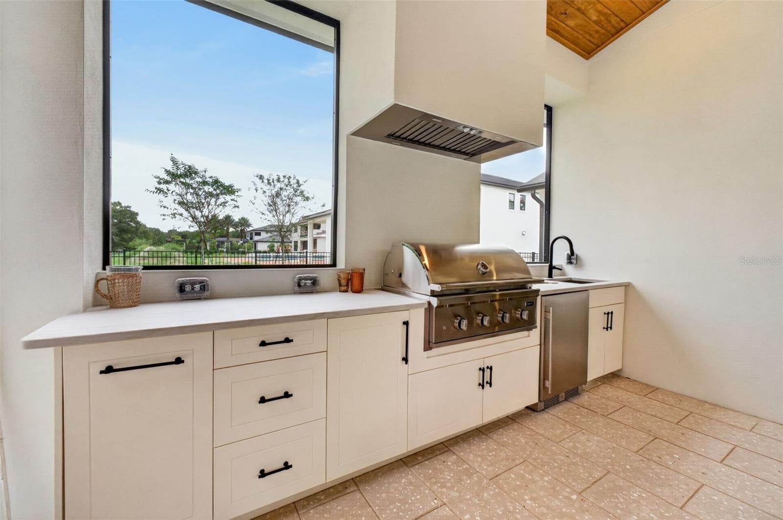 Summer kitchen complete with grill, hood, beverage refrigerator, sink and UV-stabilized High Density Polyethylene (HDPE) cabinetry - 1815 WINDERMERE RD, WINDERMERE