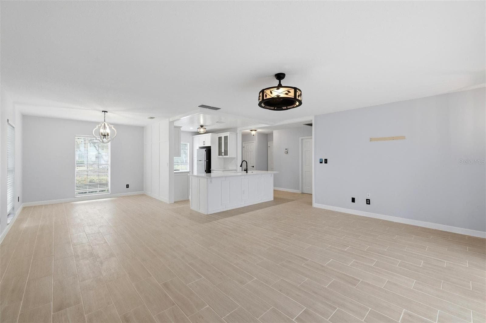 This view shows the open floorplan including living room, dining room and kitchen including a view of the newly laid tile floors throughout the home. - 4 ANTIGUA CIR #6, ENGLEWOOD