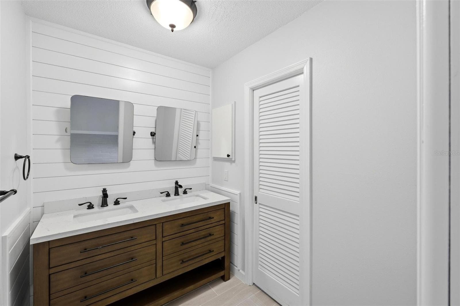 Primary ensuite bathroom with double sinks and mirrors. - 4 ANTIGUA CIR #6, ENGLEWOOD
