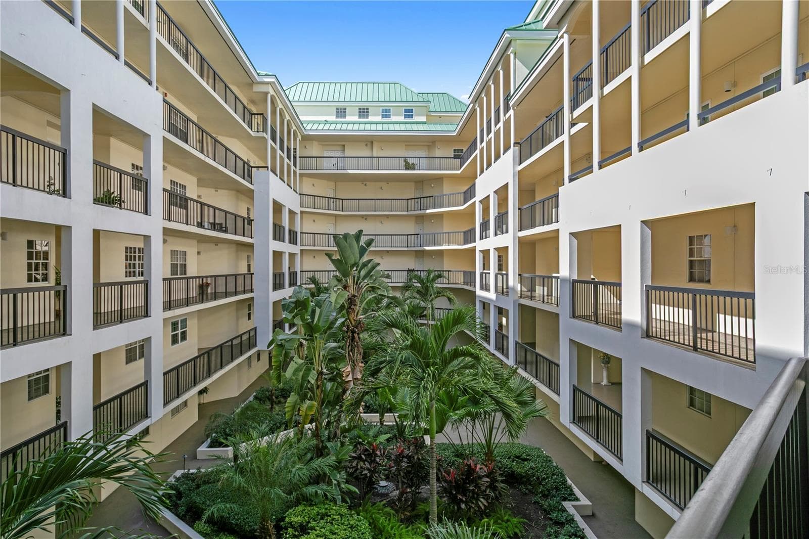 Lush, well-maintained courtyard landscaping creates a serene retreat within the condominium grounds - 1000 S HARBOUR ISLAND BLVD #2306, TAMPA