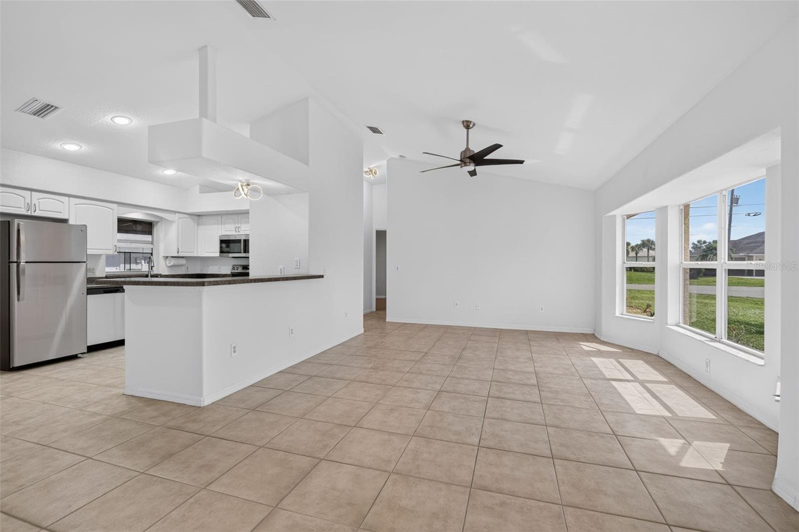 Living Room and Breakfast Bar- Another View (Tinted Windows) - 2184 ONONDAGA LN, PUNTA GORDA