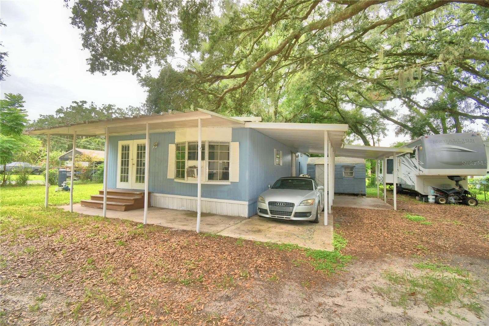 front with Carport - 217 GROVE RIDGE DR, WINTER HAVEN
