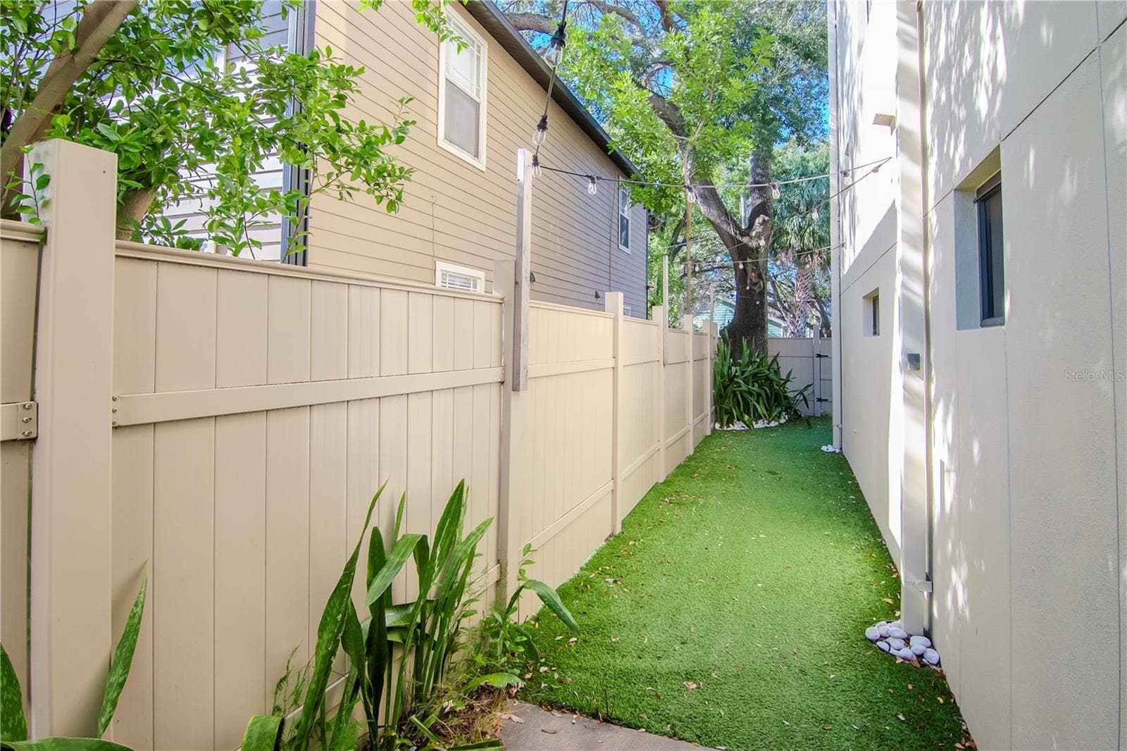 The side yard is fenced and turfed - 213 S MOODY AVE #1, TAMPA