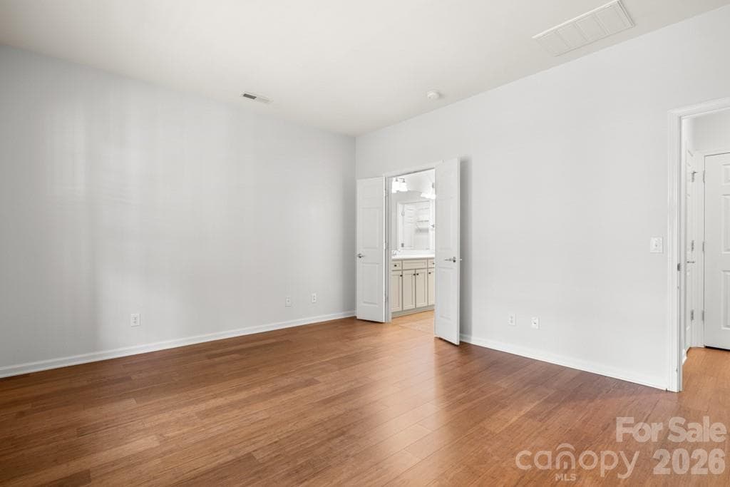 Primary bedroom with double doors to ensuite bath - 9018 Smokey Hill Lane, Indian Land