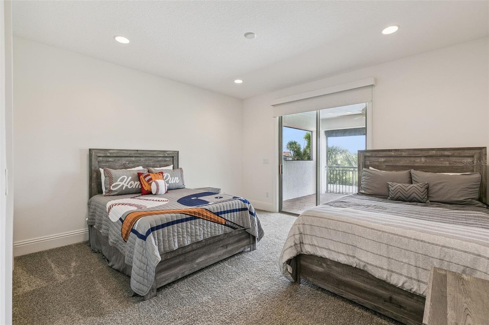 Bedroom 4 upstairs with ensuite bathroom and access to the balcony - 10840 MOBBERLEY CIR, ORLANDO