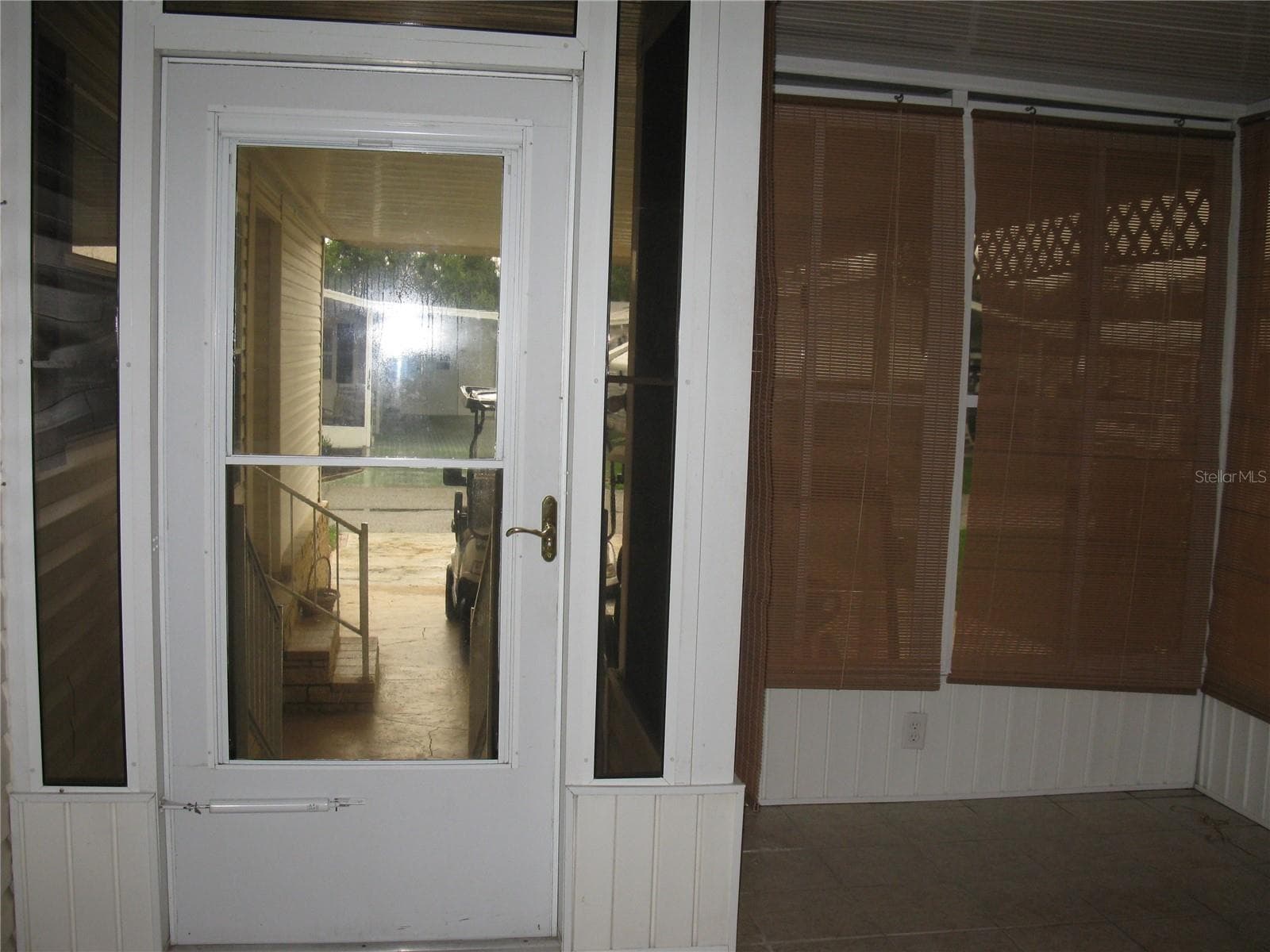 finished florida room off kitchen, entrance to driveway - 212 YORK COTTAGE DR, HAINES CITY