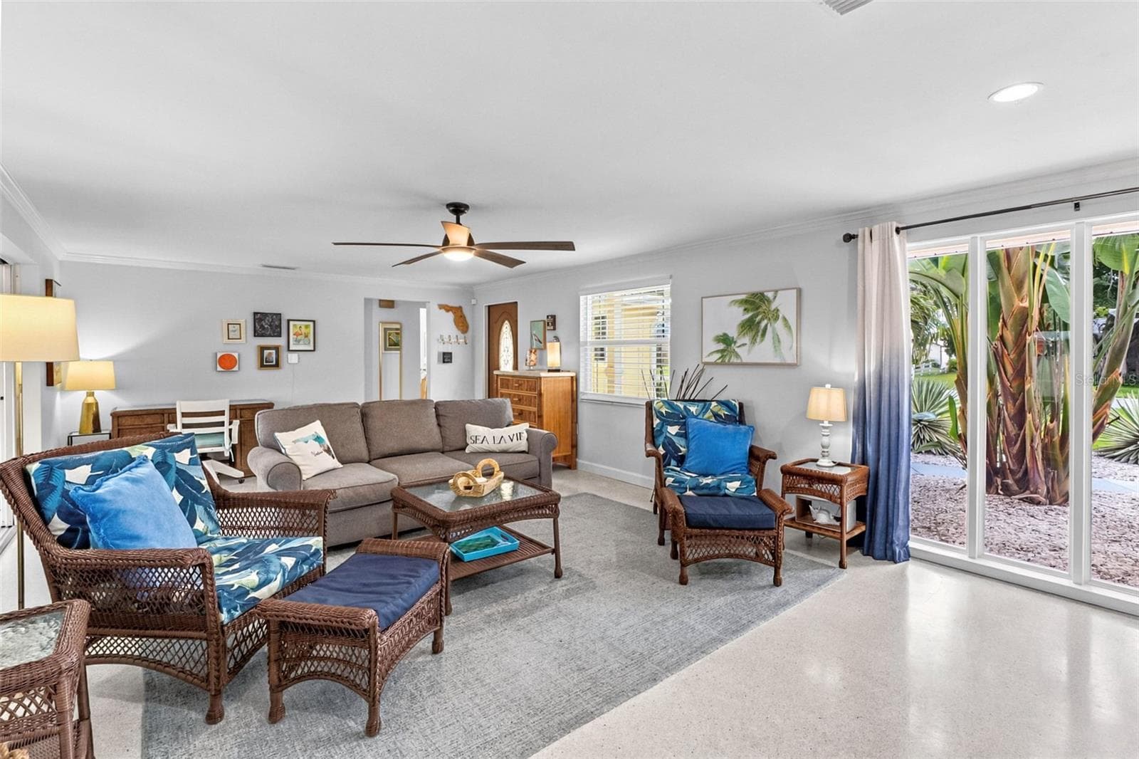 Living room seating area with tropical accents. - 912 CHURCH ST, VENICE
